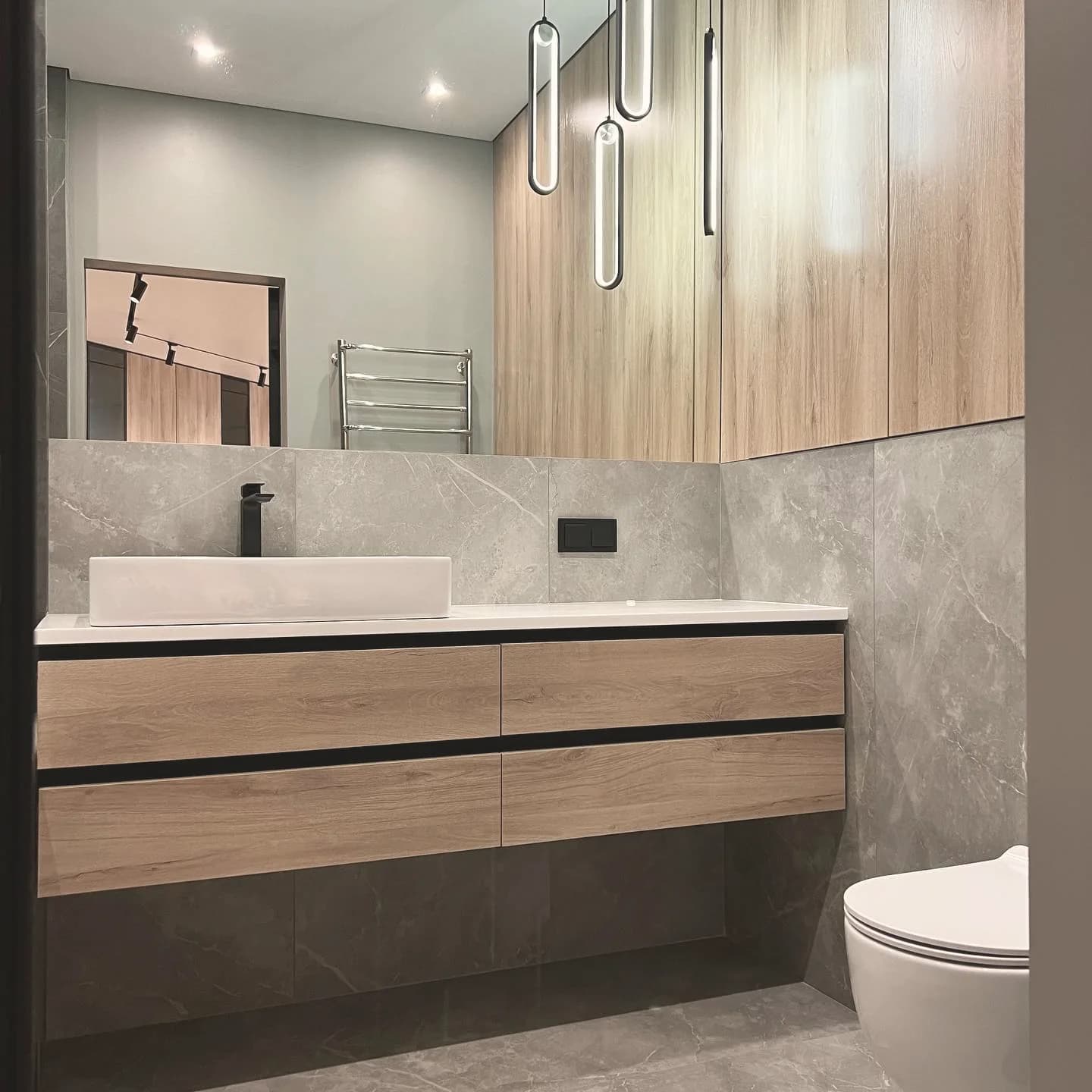 Marble bathroom with floating oak vanity — London