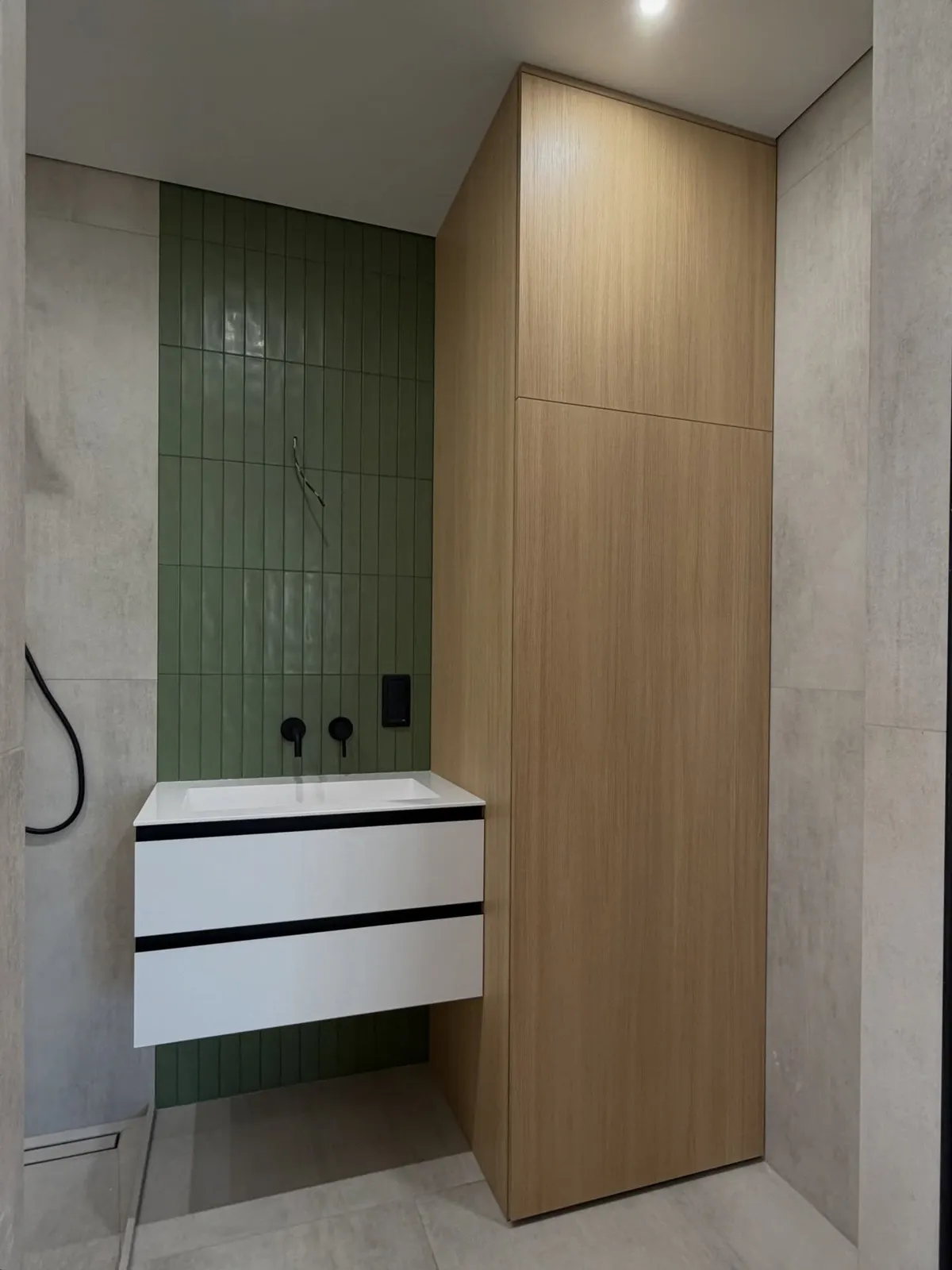 Sage tiling with oak vanity — Palmers Green, London