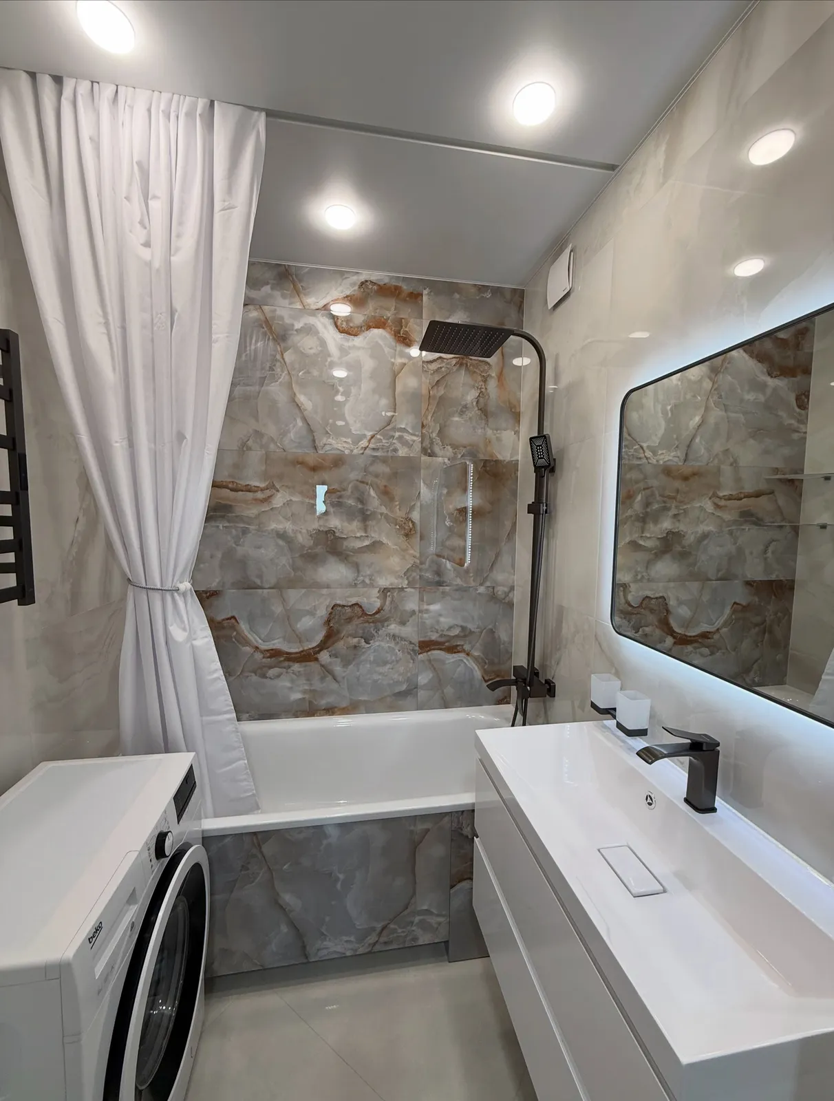 Onyx-effect bathroom with black rainfall shower — Woodford Green, Essex