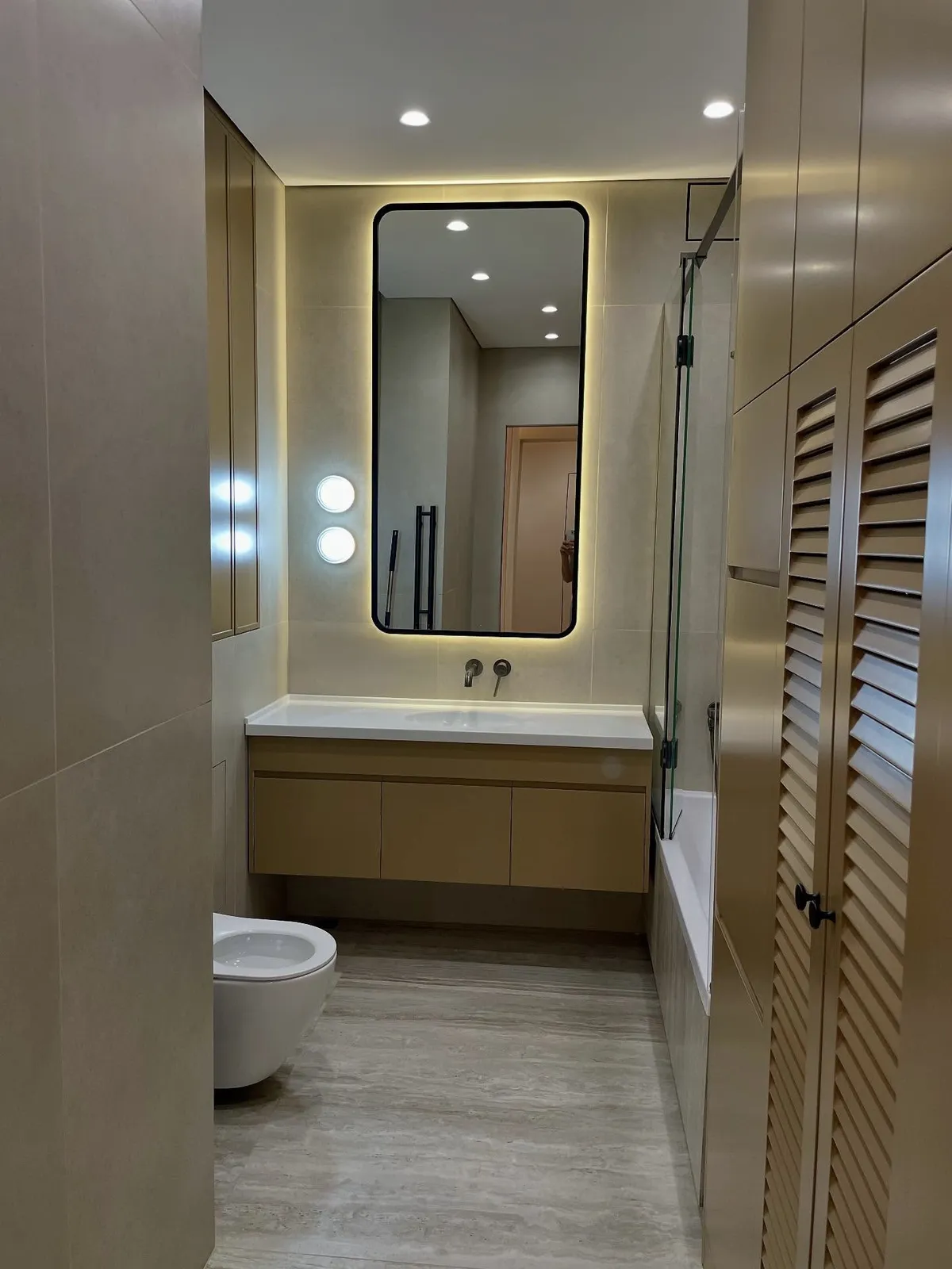 Travertine bathroom with ochre joinery — Uxbridge, London