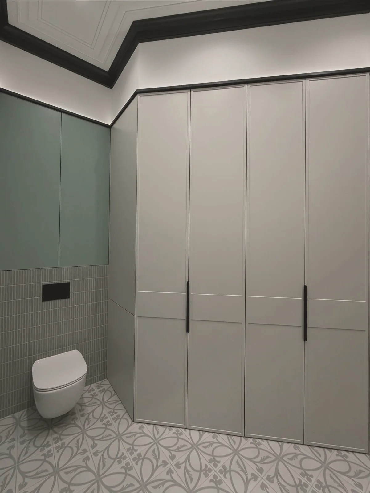 Cloakroom with concealed laundry cupboards — London