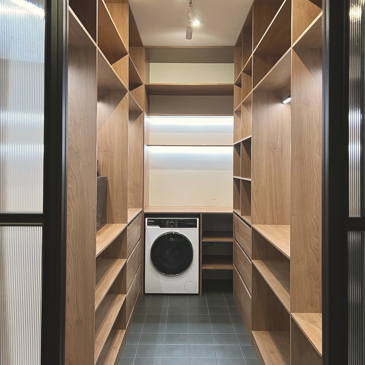 Walk-in wardrobe behind reeded glass — London
