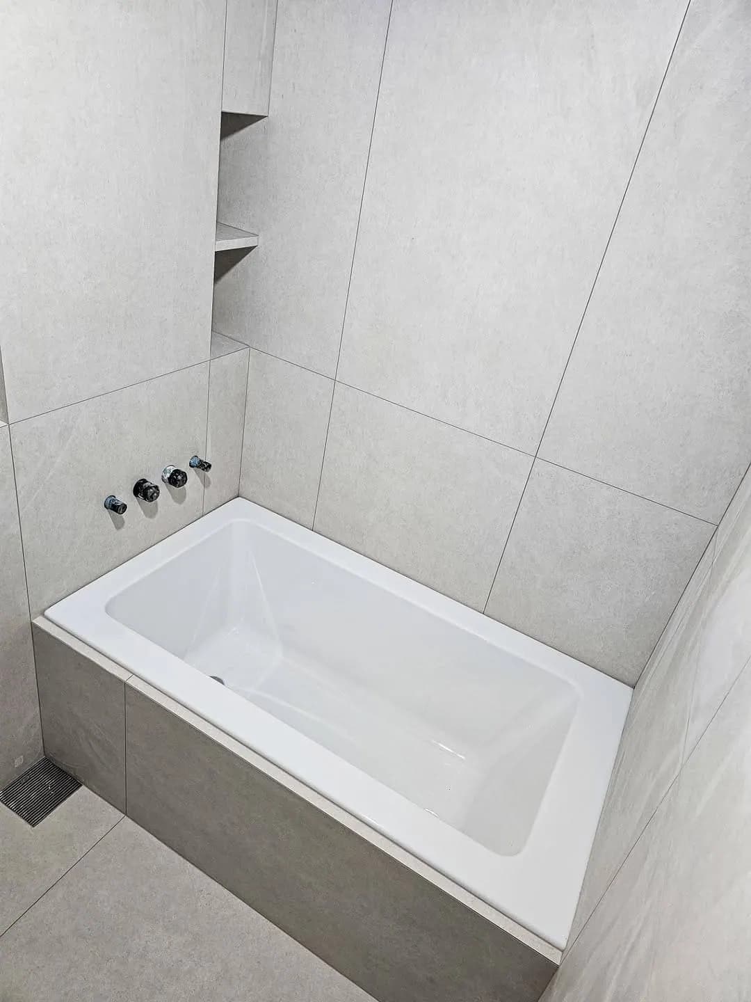 Stone-effect bathroom with inset bath — Bethnal Green, London