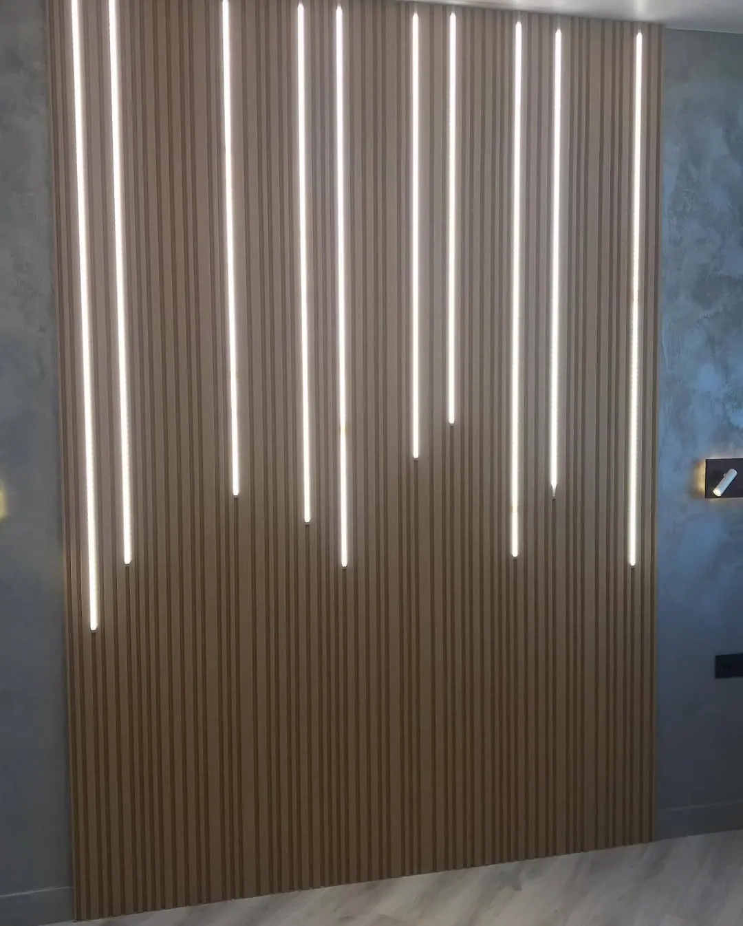 Slatted oak media wall with LED channels — Clerkenwell, London