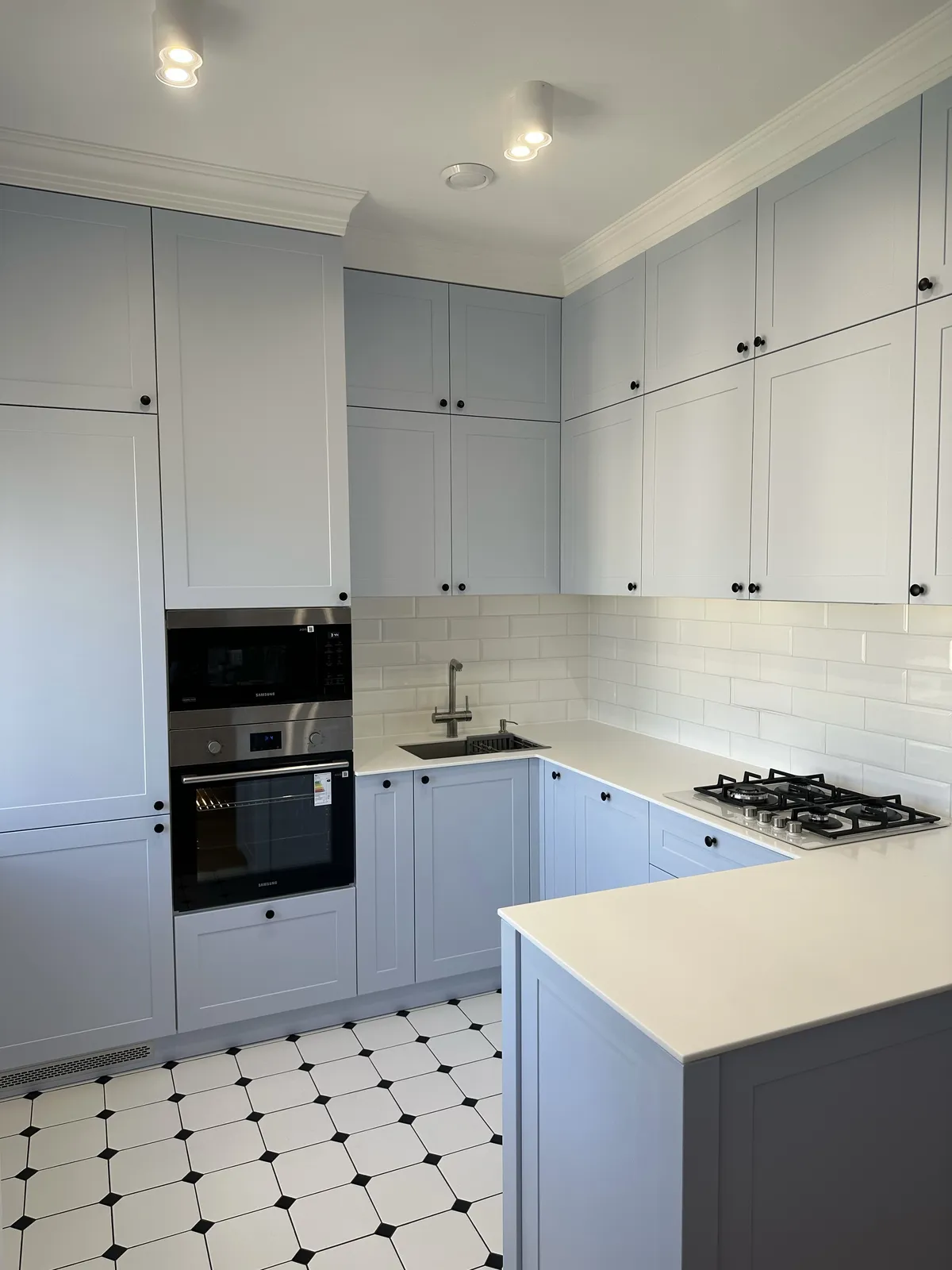 Powder-blue shaker kitchen with metro tiling — Carshalton, London