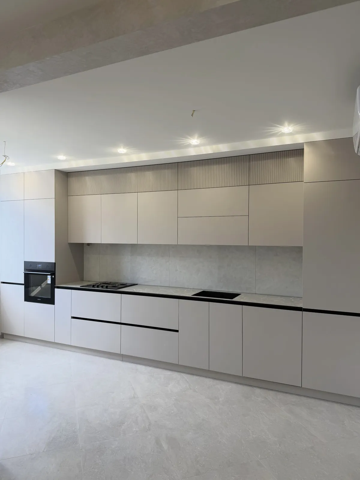 Taupe kitchen with fluted detailing — Barking, London