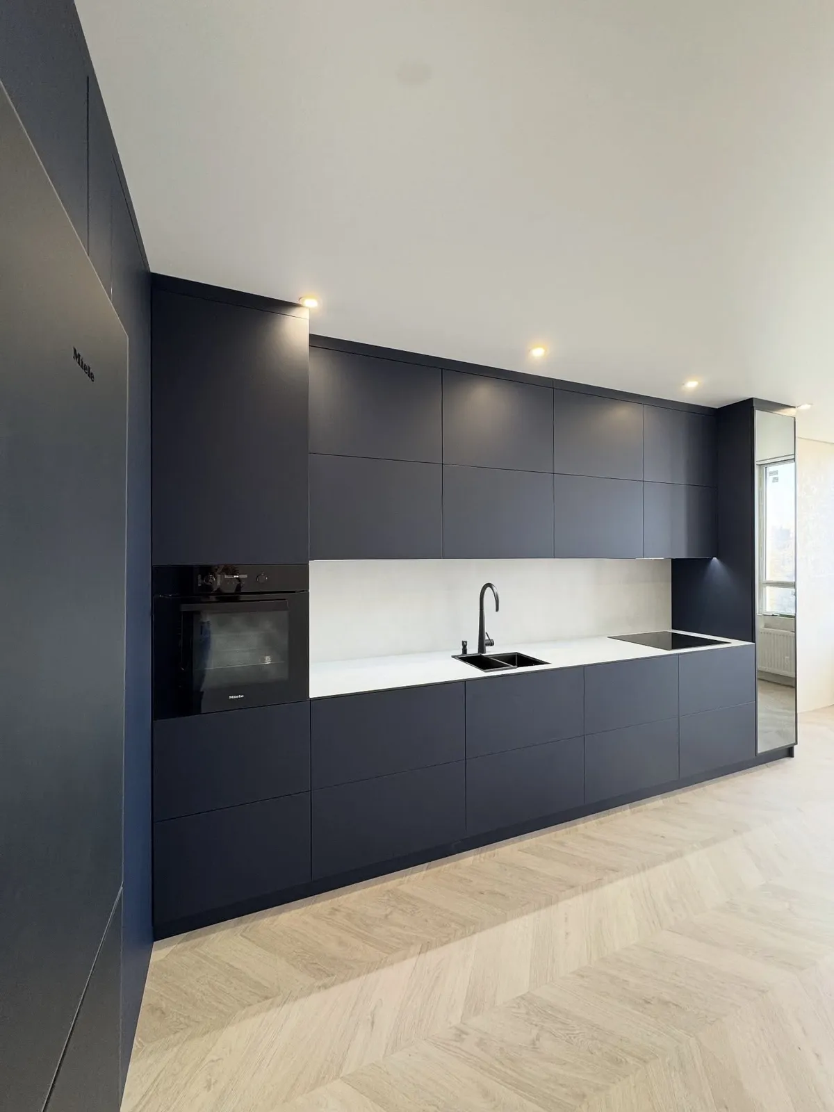 Navy kitchen with herringbone parquet — Leytonstone, London