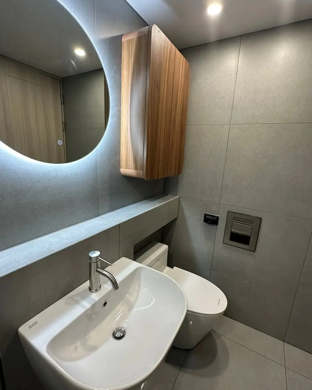 Concrete-effect bathroom with backlit mirror — North Finchley, London