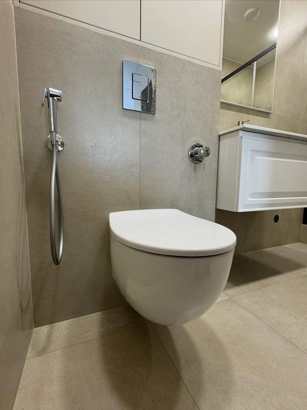 Sand-stone bathroom refit with bidet — Willesden, London