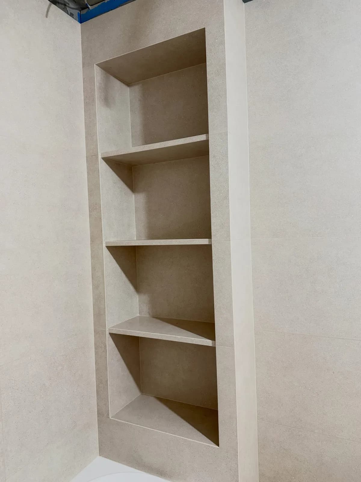 Limestone-effect bathroom with tall niche — Northolt, London