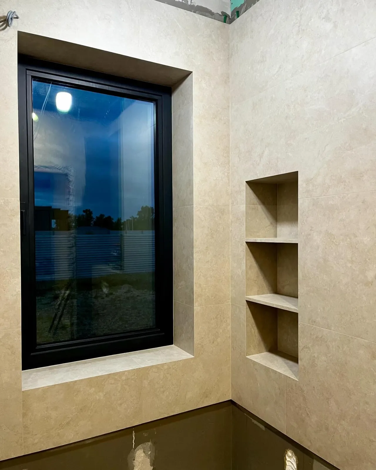 Travertine bathroom with recessed niches — Rainham, London