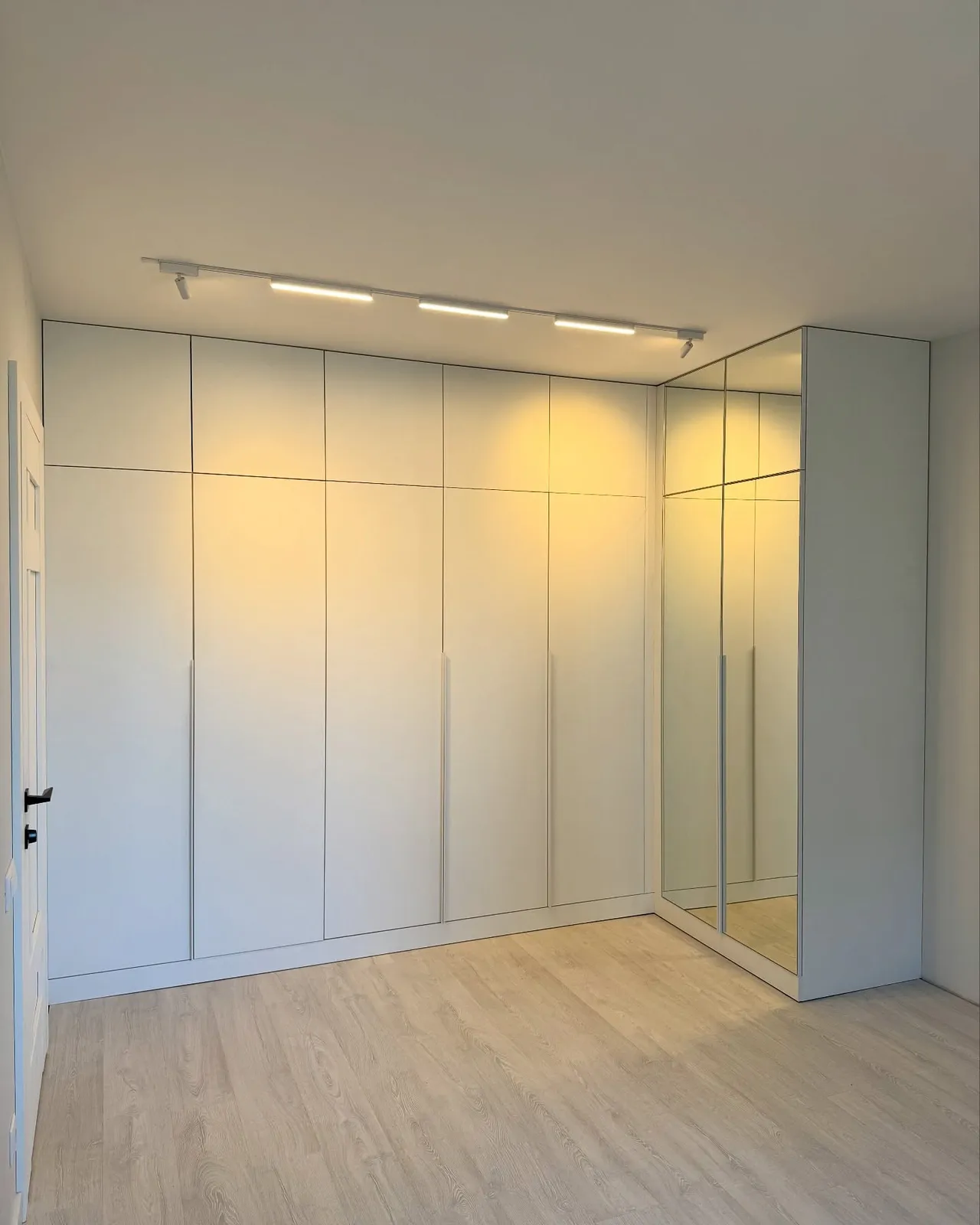 White wardrobes with mirrored corner — Bushey, Hertfordshire