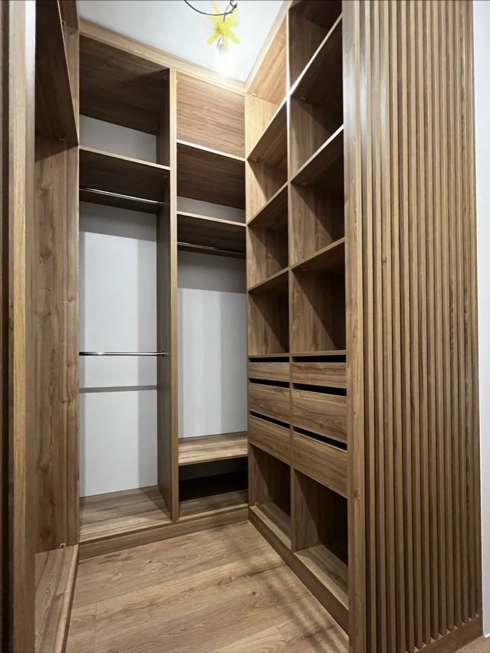 Walnut walk-in with reeded panels — Kingston upon Thames, London