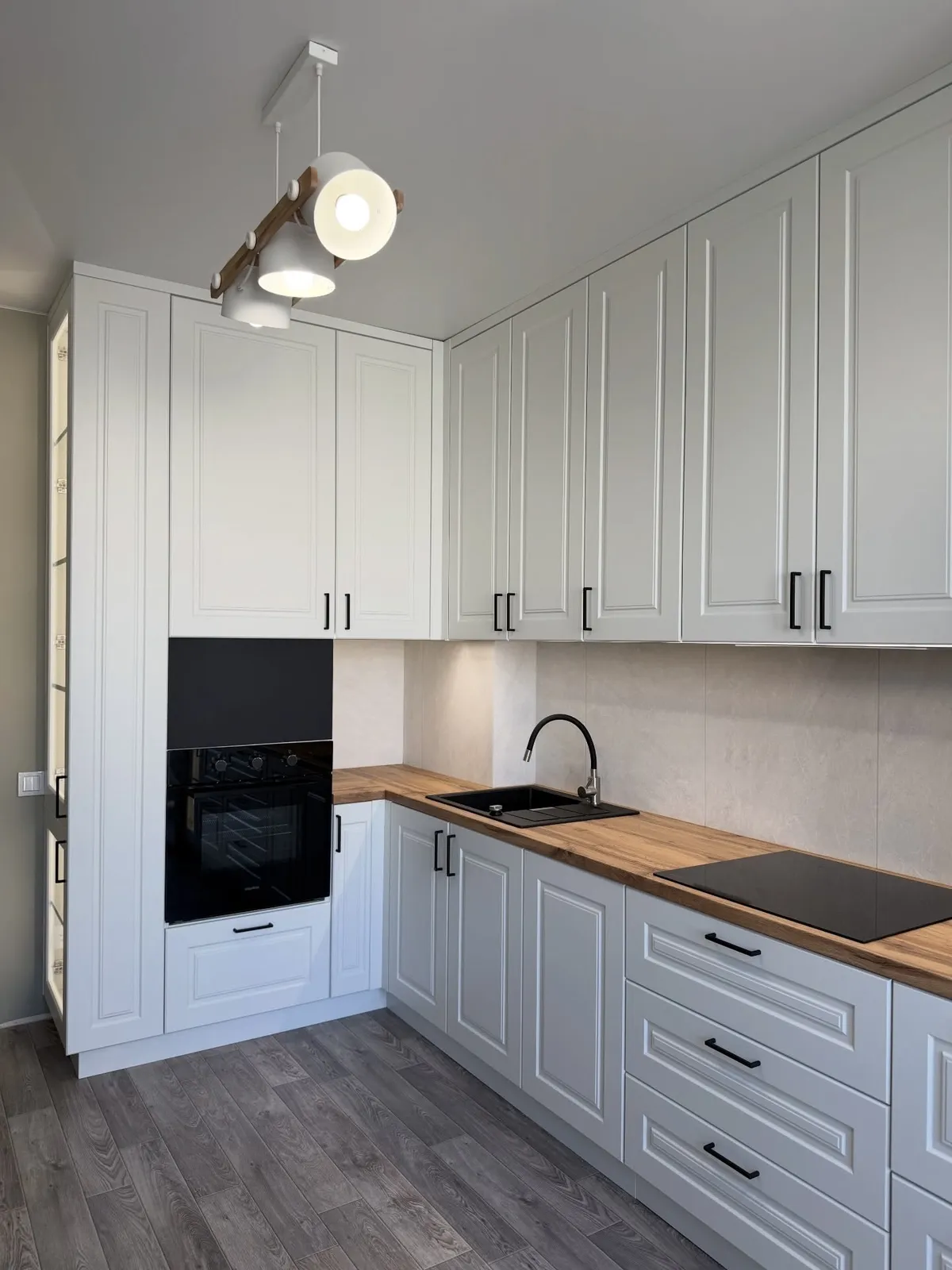 Dove-grey shaker kitchen with wood worktops, completed by PrimeCraft Surface Solutions in Grays, Essex (RM17).