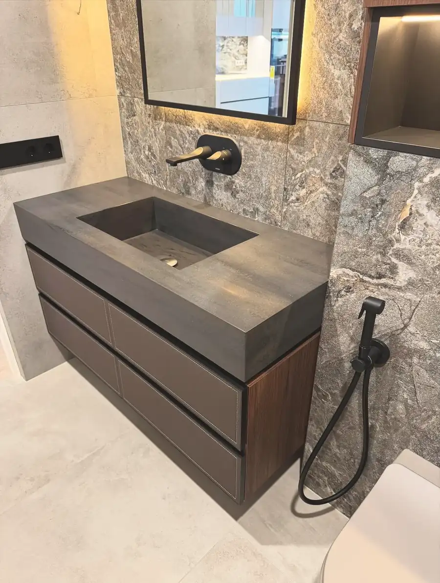 Leather-fronted vanity with stone trough basin — London